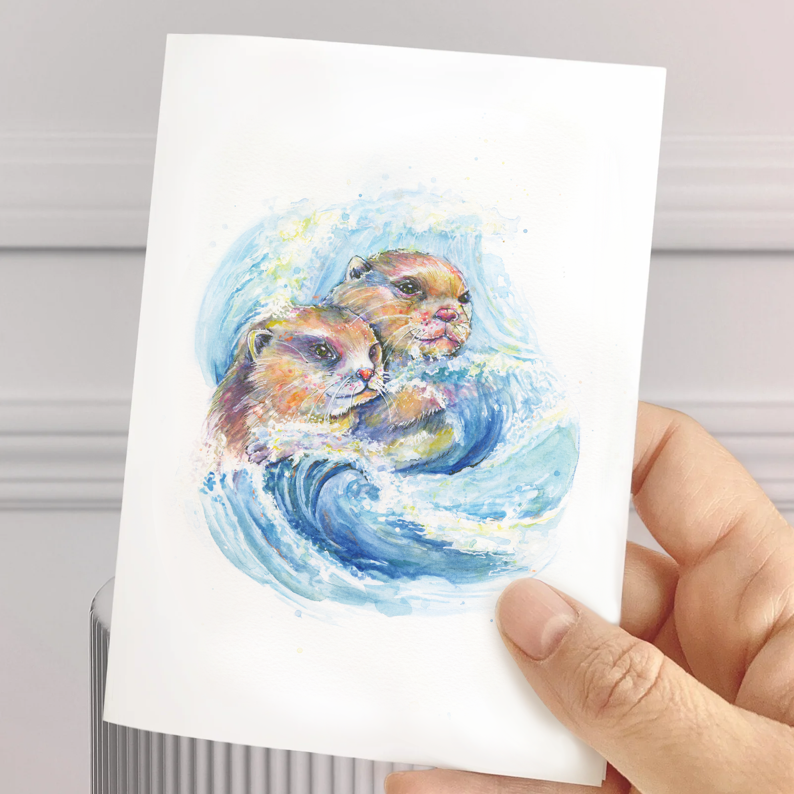 Carte de souhait aquarelle – deux loutres dans une vague